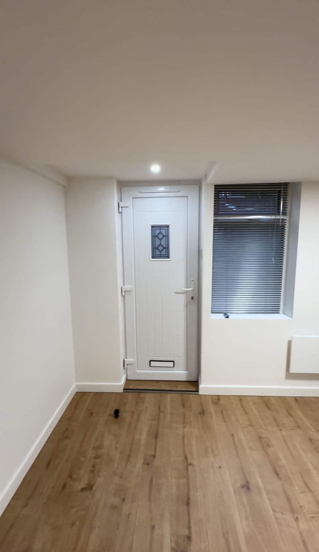 Converted room finished with oak flooring, new door and window
