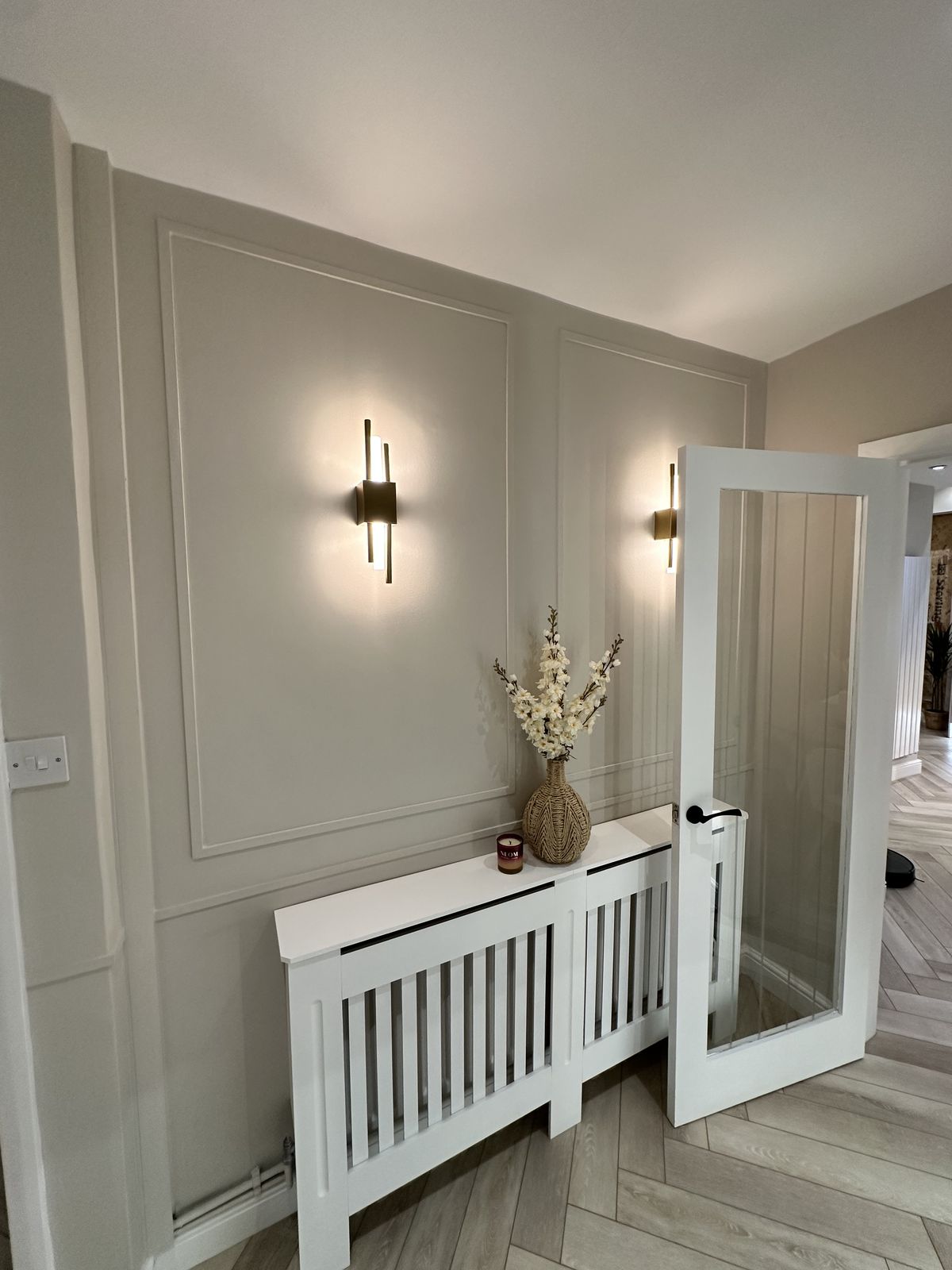 Hallway with wall panelling and wall lights